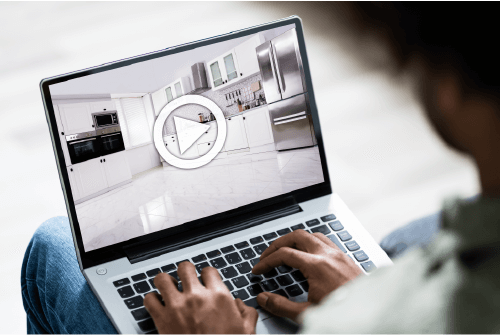 a man looking at his laptop to see a home online by virtual showing