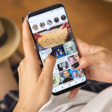 A lady scrolling on Instagram search to grow Instagram followers on her account.
